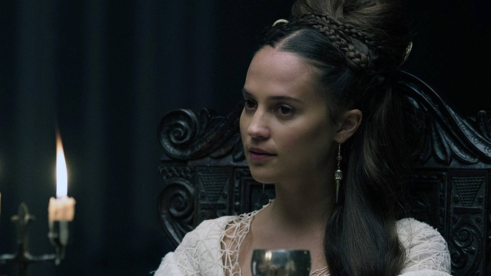 Alicia Vikander at a fancy dinner table in The Green Knight