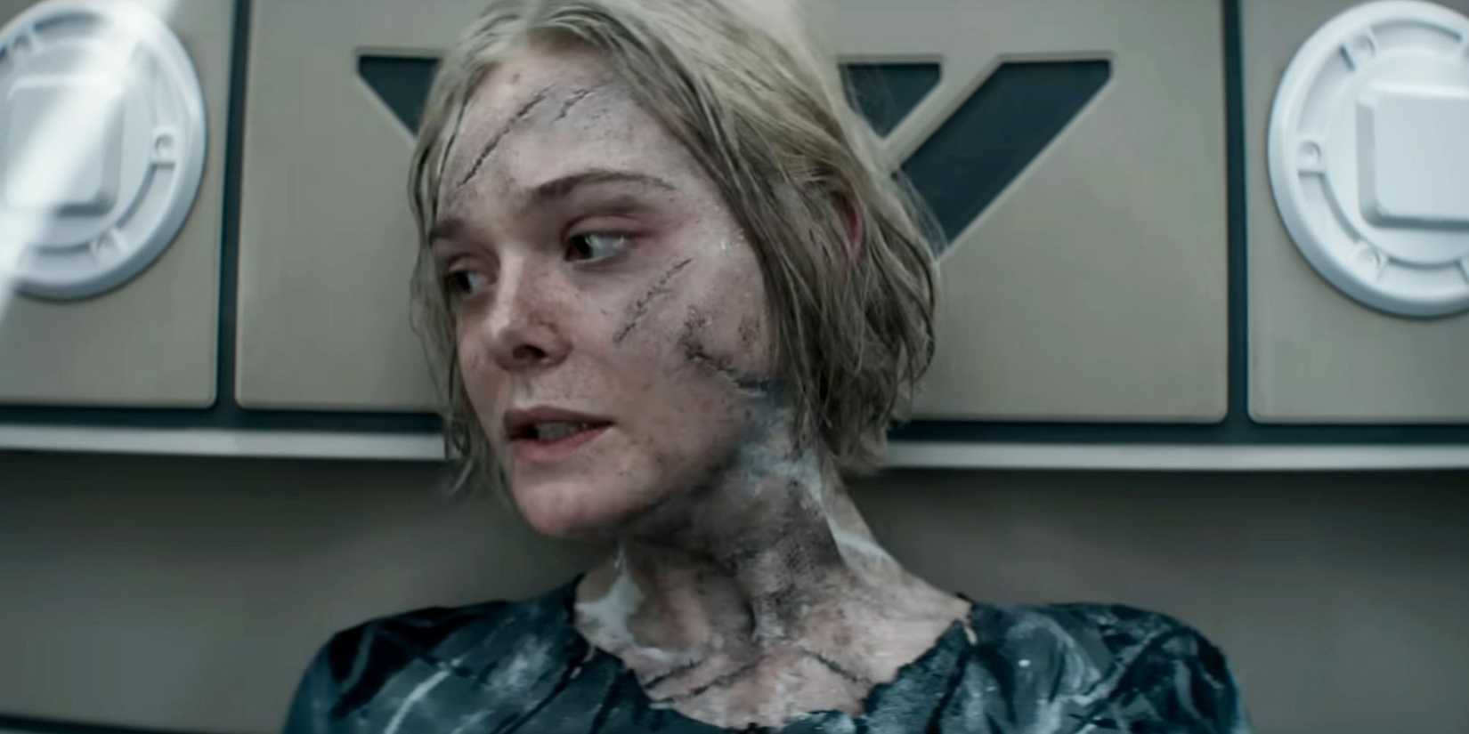 Elle Fanning, cut up and worried, sits in a spacecraft in Predator: Badlands