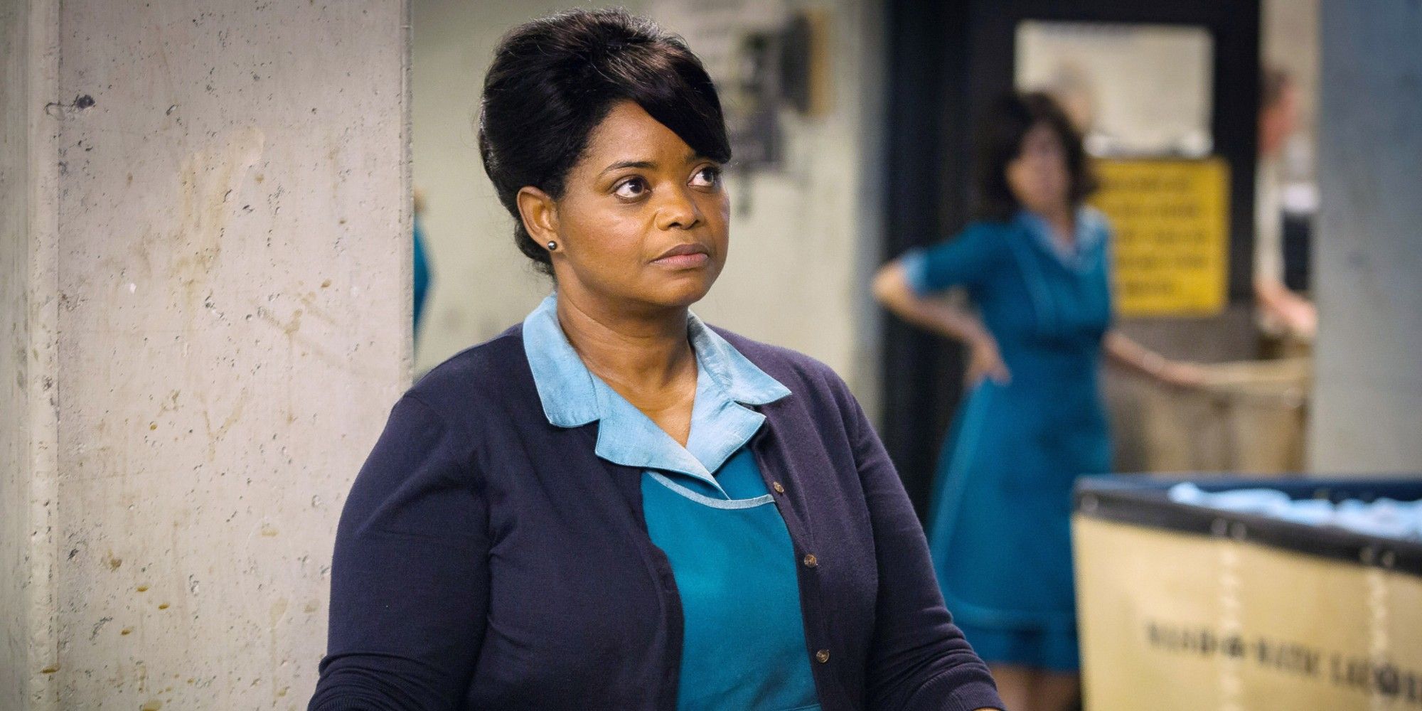 Octavia Spencer looking at someone while on duty as a maid in a science lab in Shape of Water