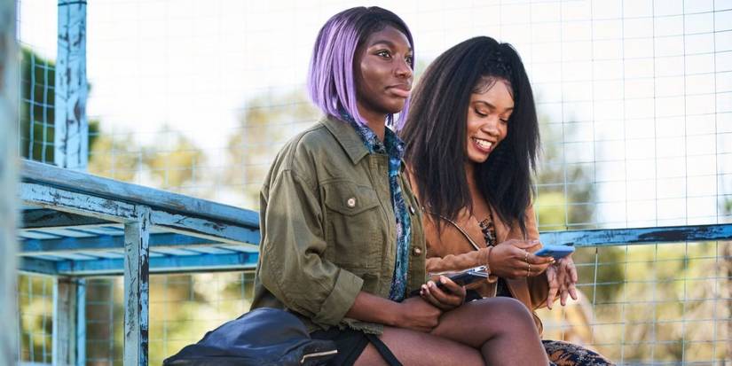Michaela Coel as Arabella and Weruche Opia as Terry sitting side by side in I May Destroy You