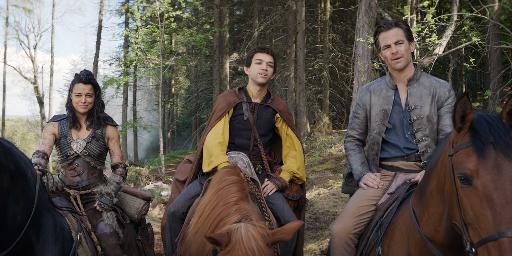 Michelle Rodriguez, Justice Smith, and Chris Pine on horseback looking ahead in Dungeons and Dragons: Honor Among Thieves