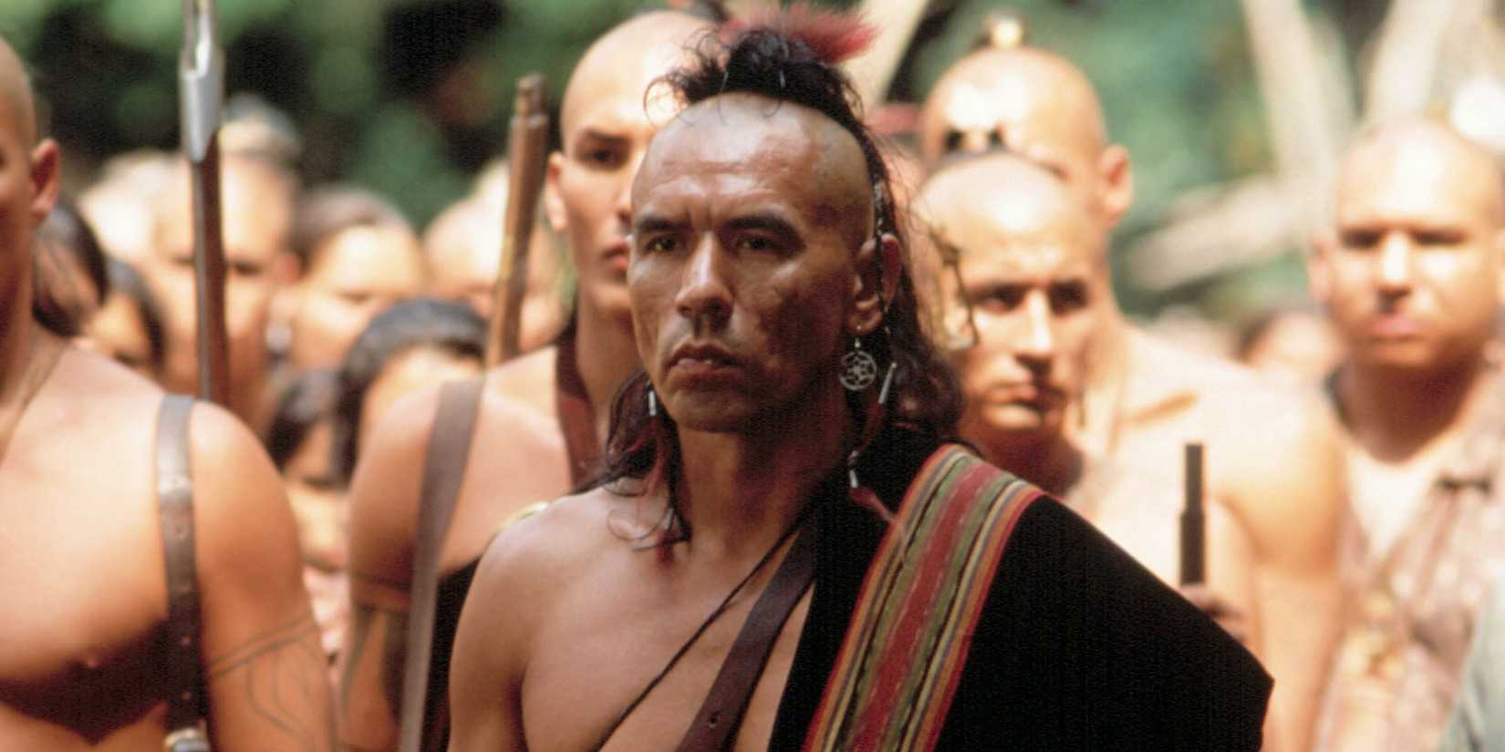 A Native American chief stands with his people in Last of the Mohicans