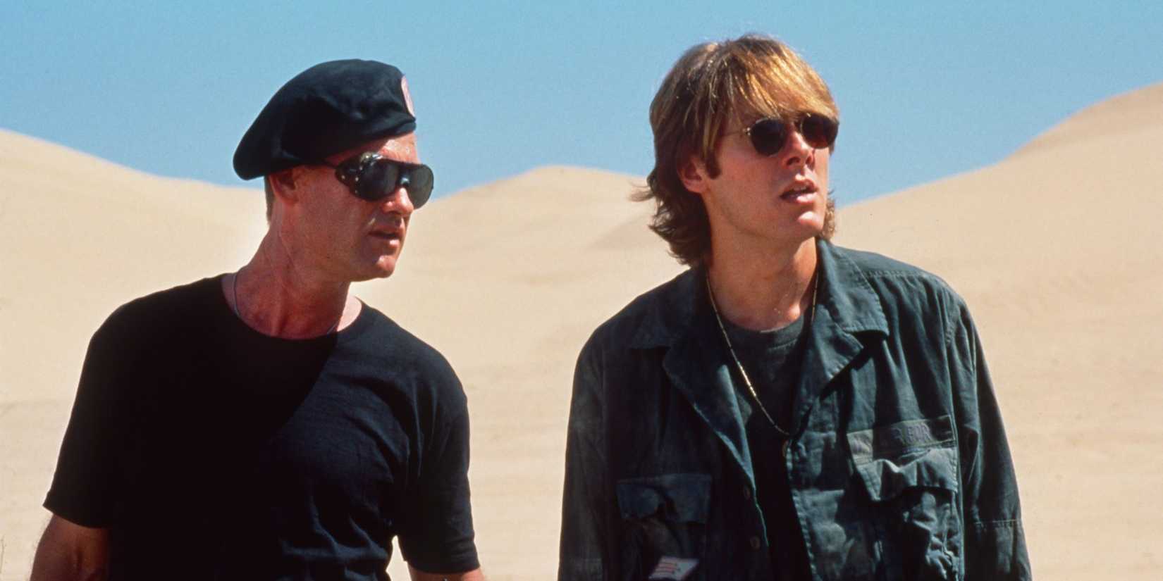 Kurt Russell & James Spader wearing sunglasses in the desert in Stargate