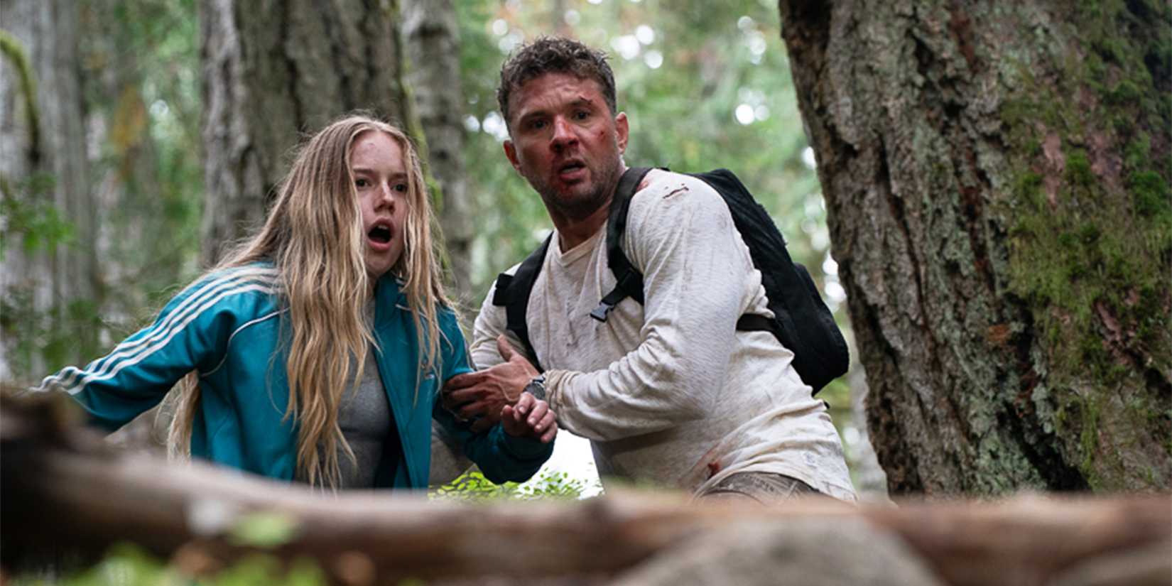 Alex and Danny look down a hill at something, appearing frightened. 