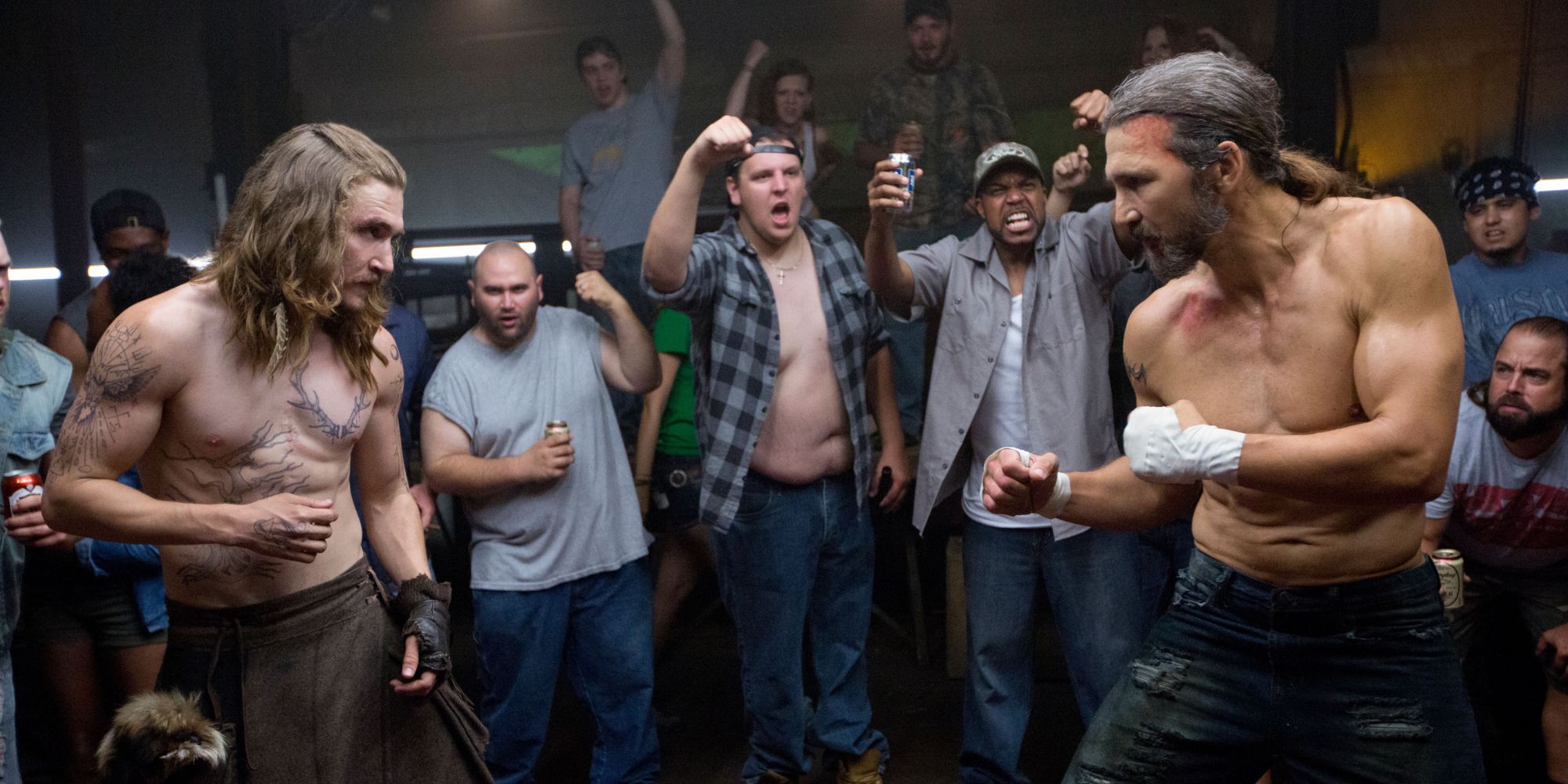 Two shirtless men squaring up to fight