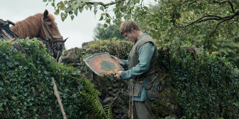 Dunk (Peter Claffey) looks at his shield in A Knight of the Seven Kingdoms​​​​​​​ 