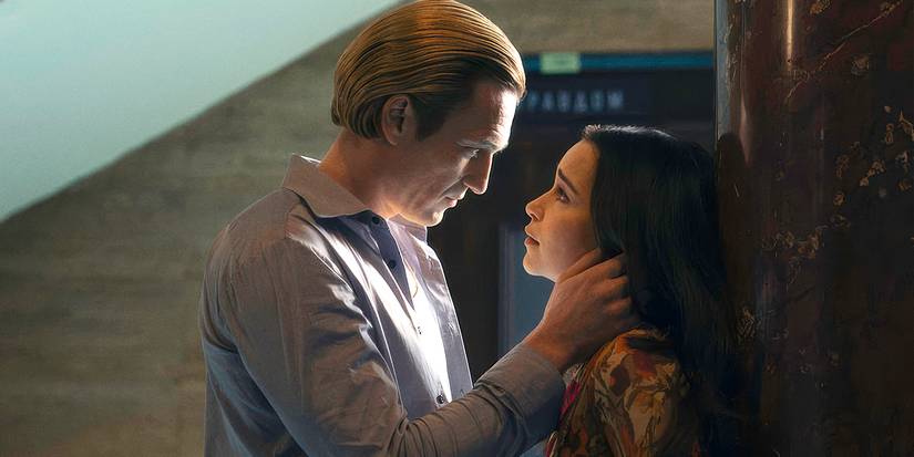 Emilia Clarke as Bea with Artjom Gilz as Andrei holding the side of her neck in Ponies Season 1