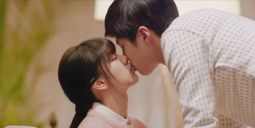 Park Bo-gum leaning down and kissing Hyeri who is sitting in Reply 1988