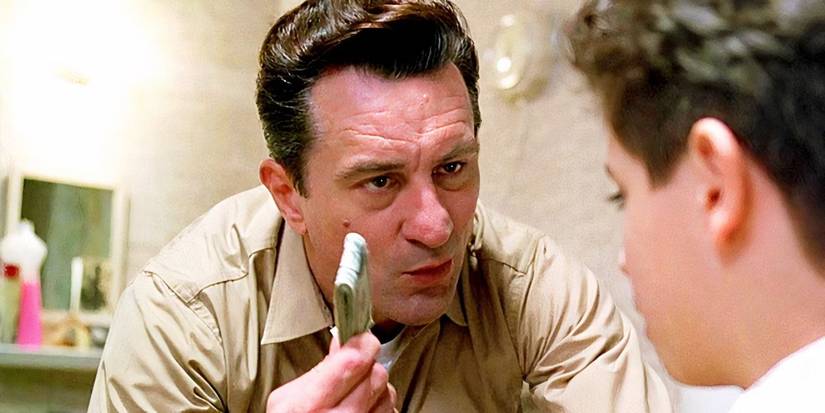 Robert De Niro holding up a wad of bills in A Bronx Tale