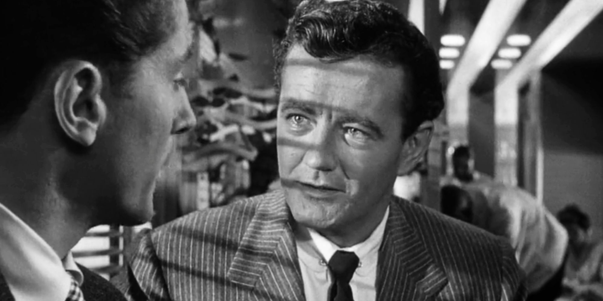 Robert Walker looking at Farley Granger standing next to him in Strangers on a Train (1951)