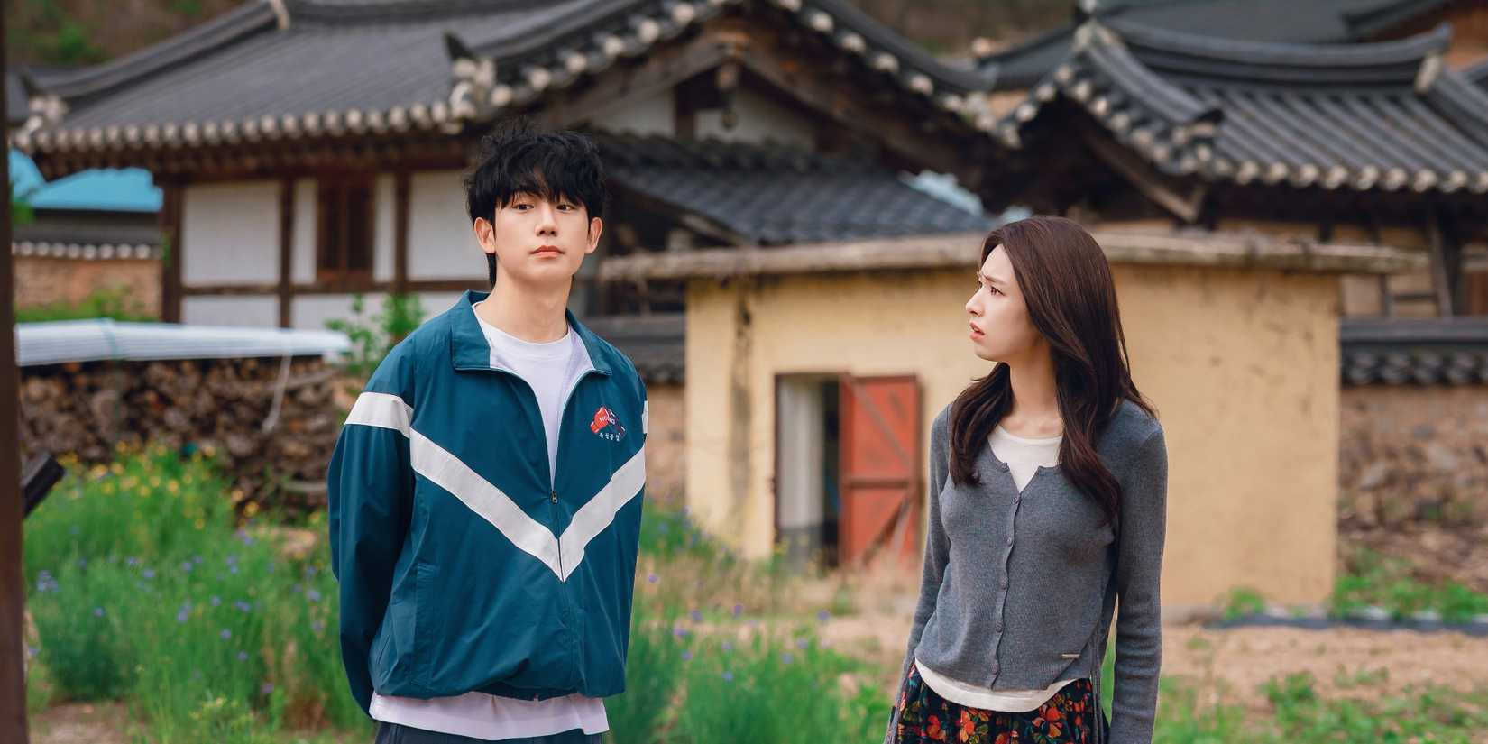 Jung Hae-in and Ha Young standing in the streets, with him looking away and her looking at him in Our Sticky Love