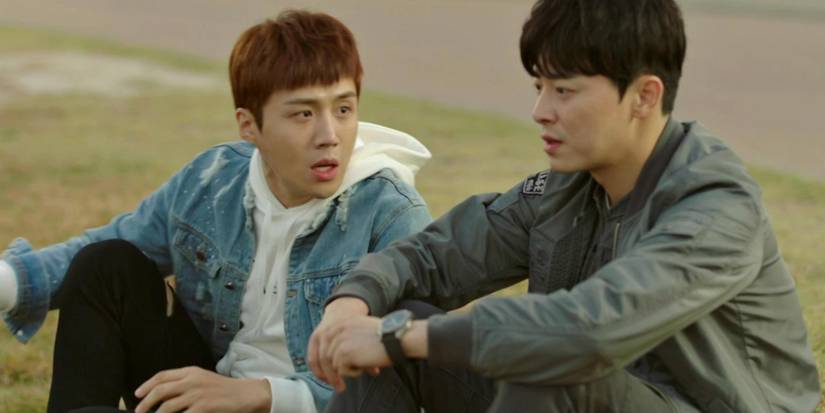 Jo Jung-suk and Kim Seon-ho arguing while sitting on the ground in Two Cops.