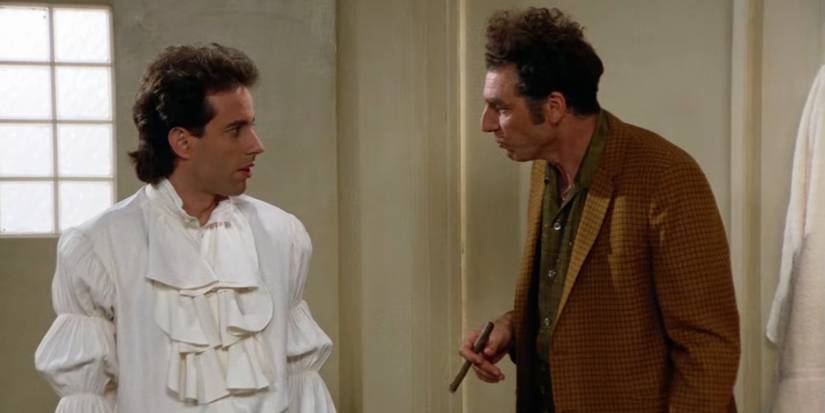 Seinfeld wearing a puffy white shirt and talking to Kramer.