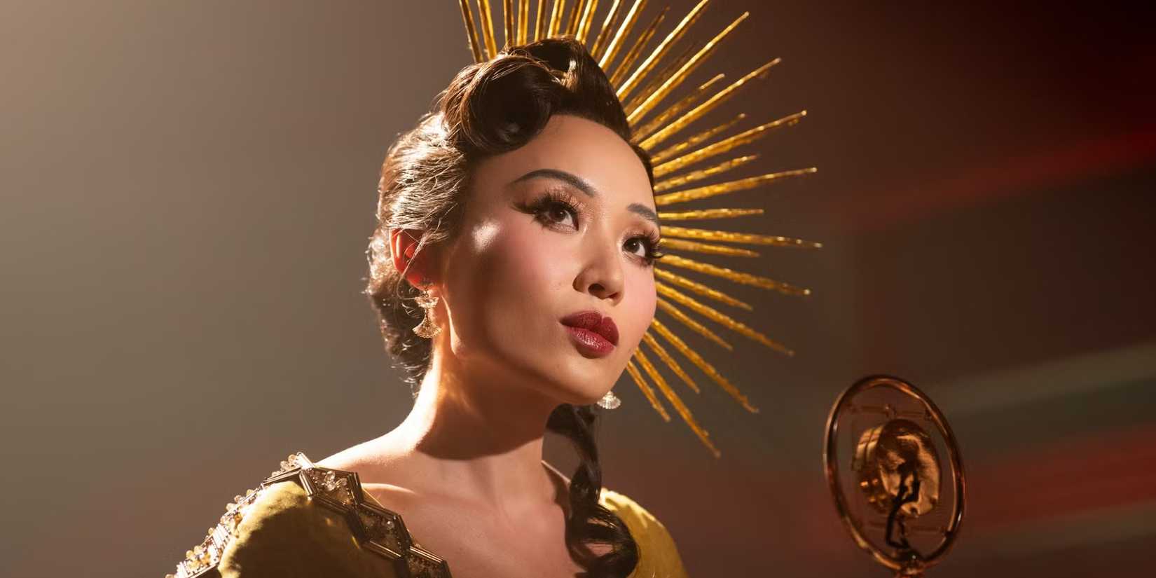 Li Jun Li standing at a microphone in Spider-Noir