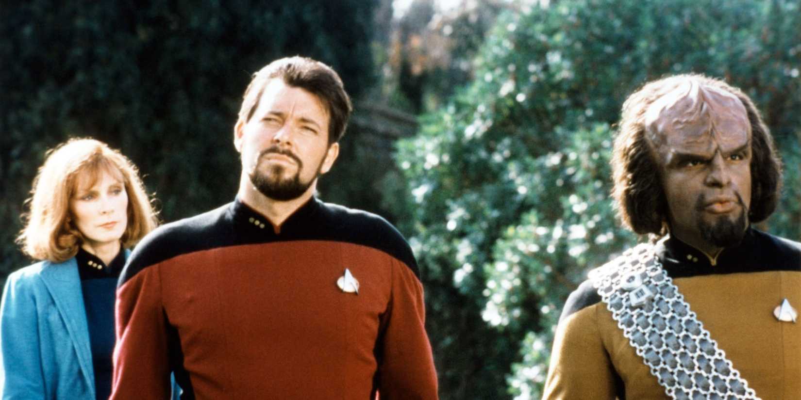 Gates McFadden, Jonathan Frakes, and Michael Dorn on a planet with trees in Star Trek: The Next Generation