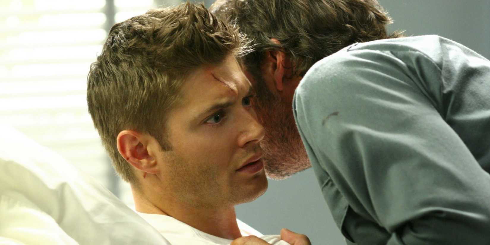 John Winchester (Jeffrey Dean Morgan) whispers into Dean Winchester's (Jensen Ackles) ear in the 'Supernatural' episode "In My Time of Dying"