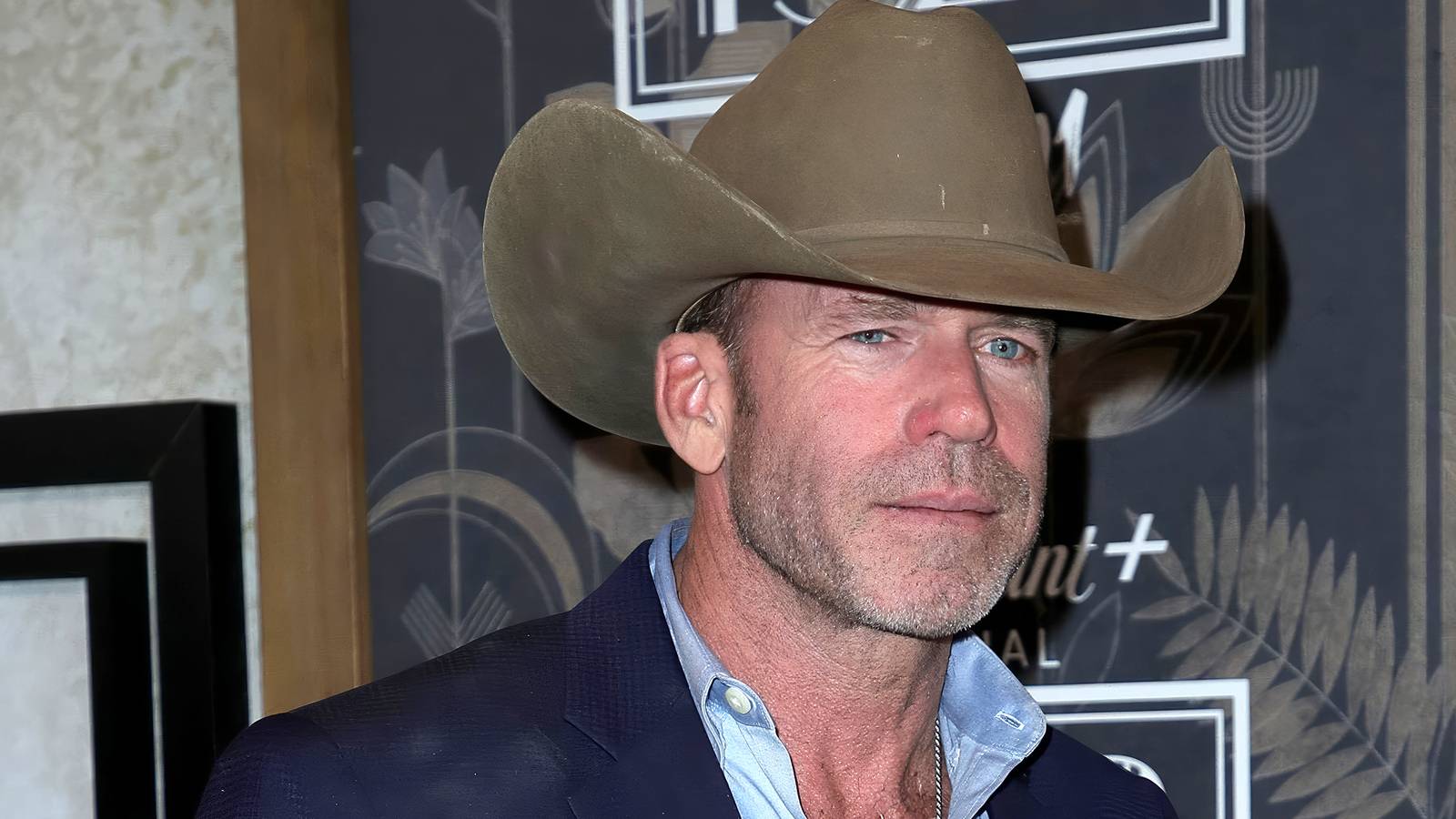 Taylor Sheridan wears a cowboy hat on the red carpet
