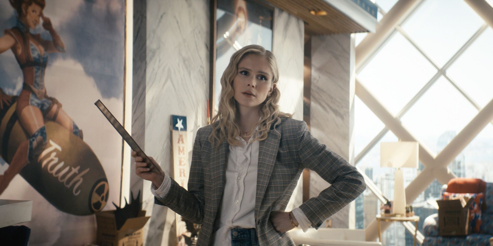 Erin Moriarty as Annie January in 'The Boys' wears a plaid blazer and holds a ruler