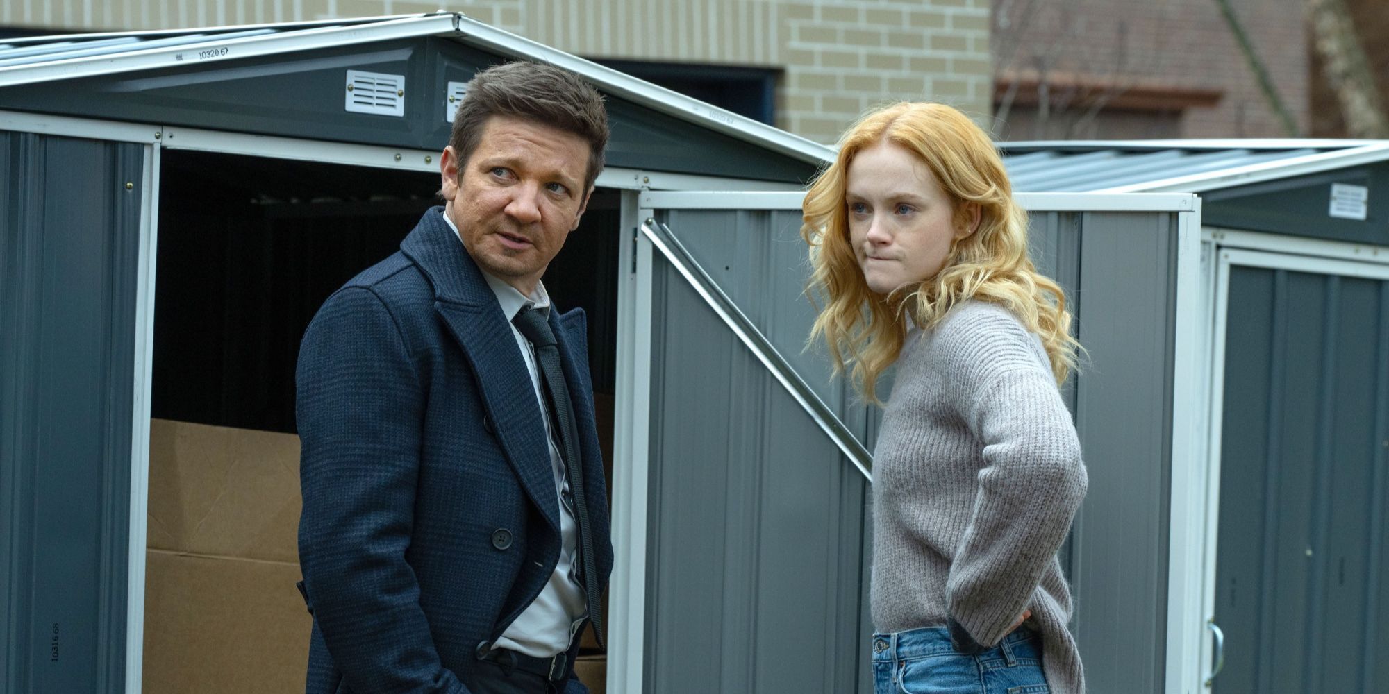 Jeremy Renner & Emma Laird stand together outside in Mayor of Kingstown