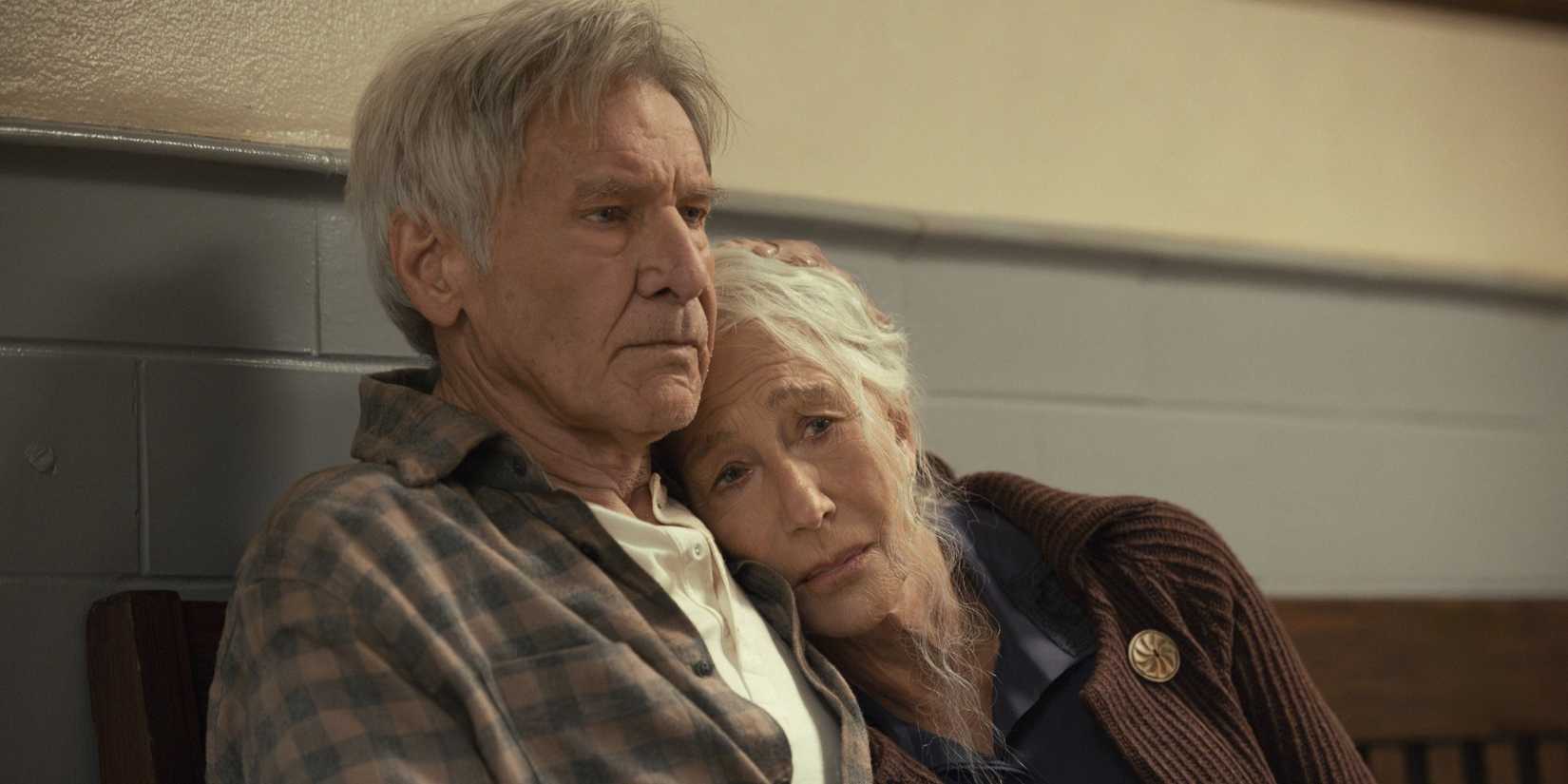 Helen Mirren leaning on Harrison Ford for comfort in a station hallway in 1923