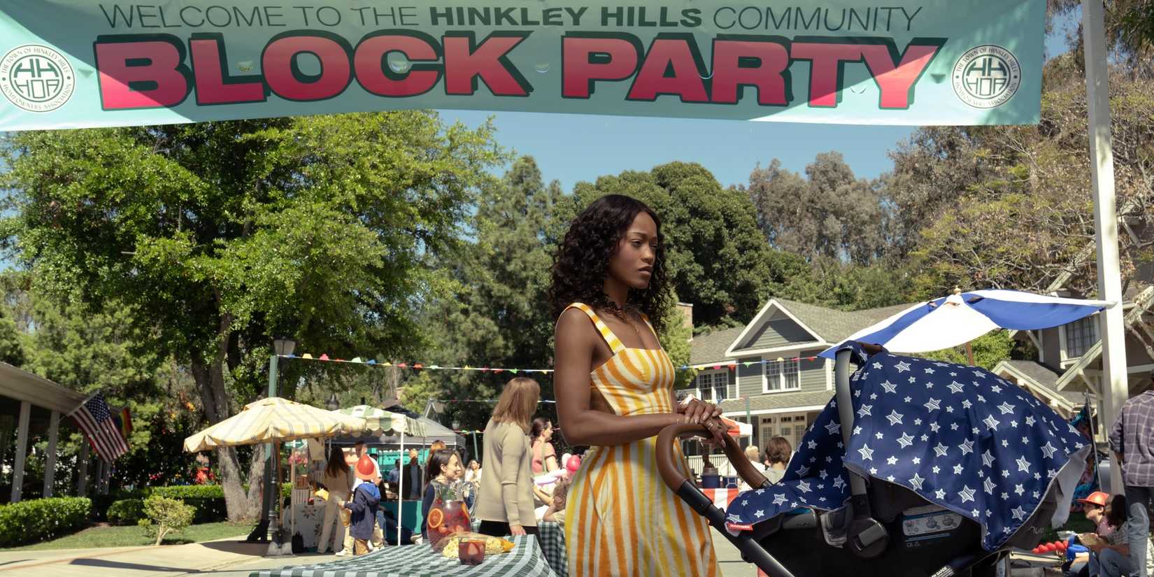 Keke Palmer as Samira Fisher pushing a baby carriage at the Hinkley Hills Block Party in The 'Burbs