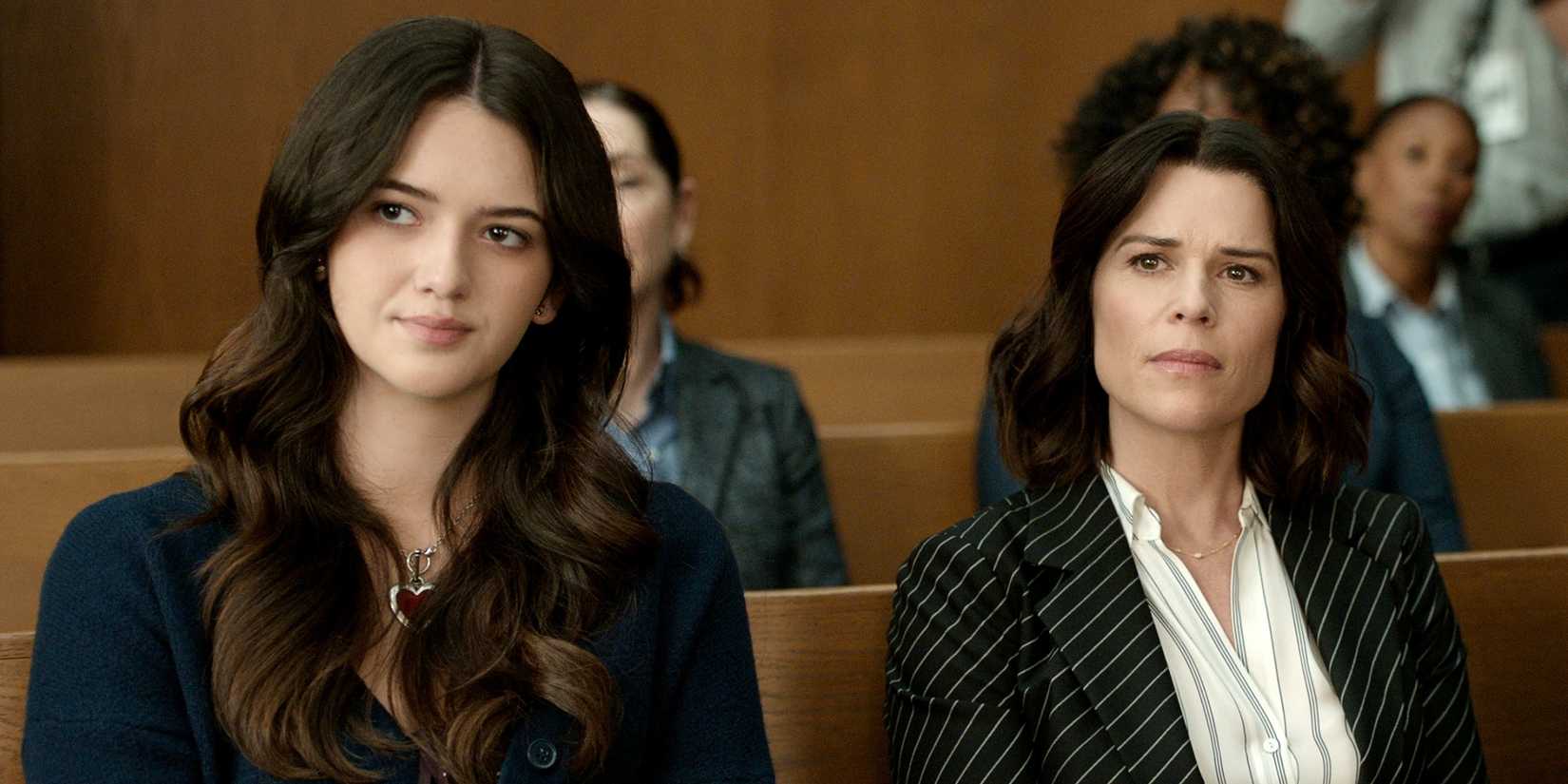 Neve Campbell as Maggie sitting in court with Kara Warner as Hayley in The Lincoln Lawyer Season 4