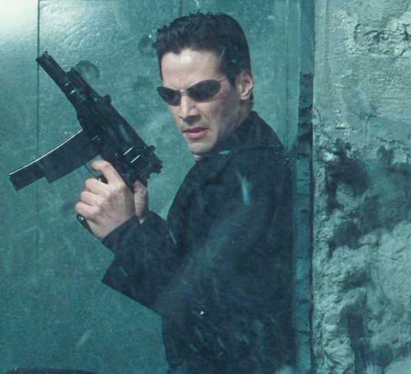 Neo holding a gun in The Matrix