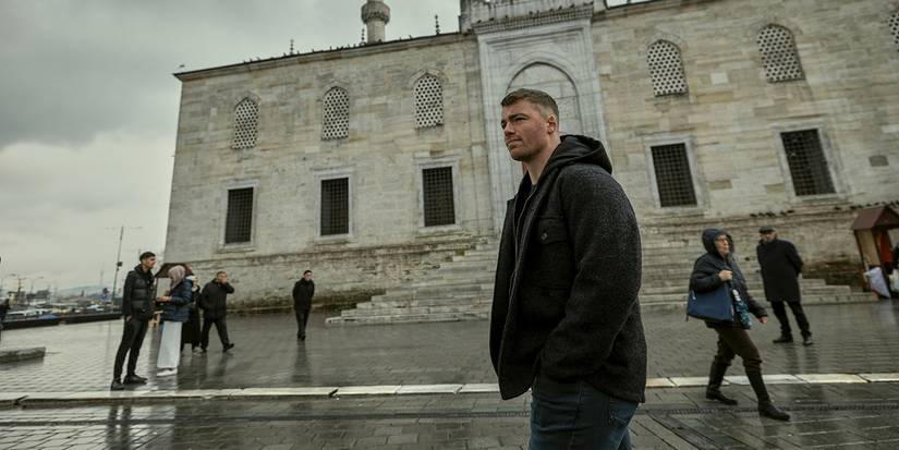 Peter walking alone, hands in his pocket, looking relaxed in The Night Agent.