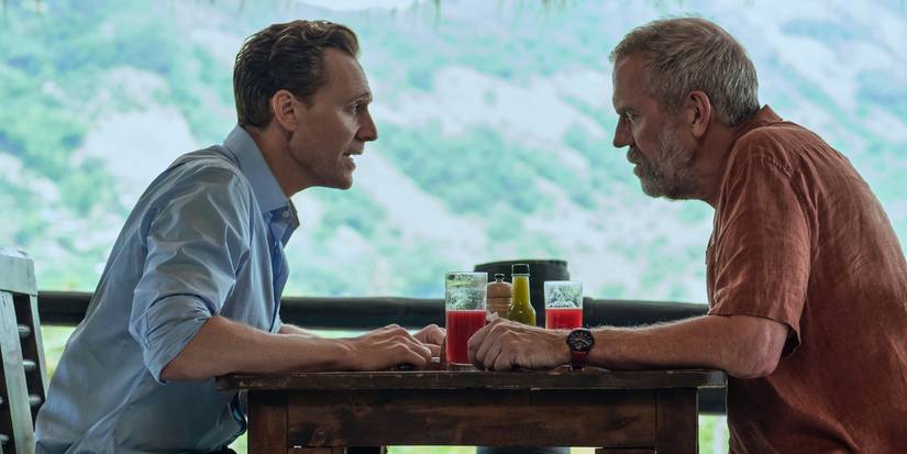 Tom Hiddleston as Jonathan Pine and Hugh Laurie as Richard Roper talking over a diner table in 'The Night Manager.'