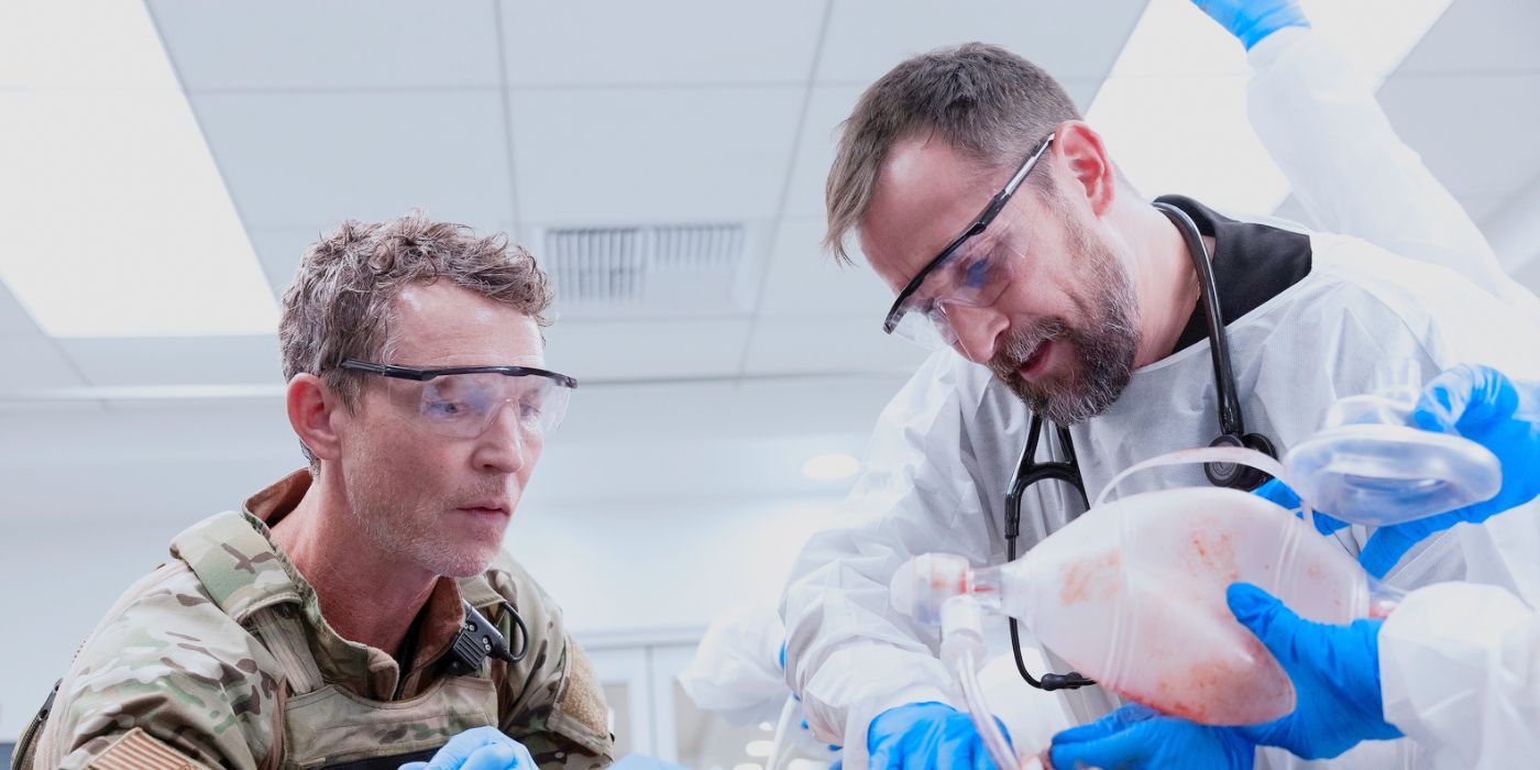 Dr. Abbot and Dr. Robby leaning over an injured patient in The Pitt Season 2 Episode 7