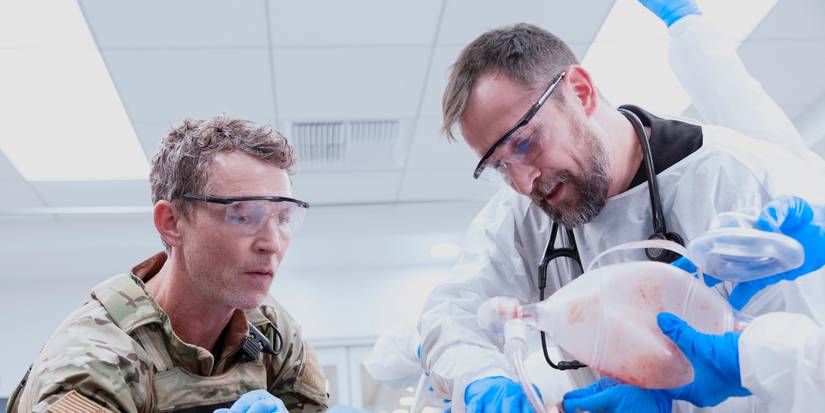 Dr. Abbot and Dr. Robby leaning over an injured patient in The Pitt Season 2 Episode 7