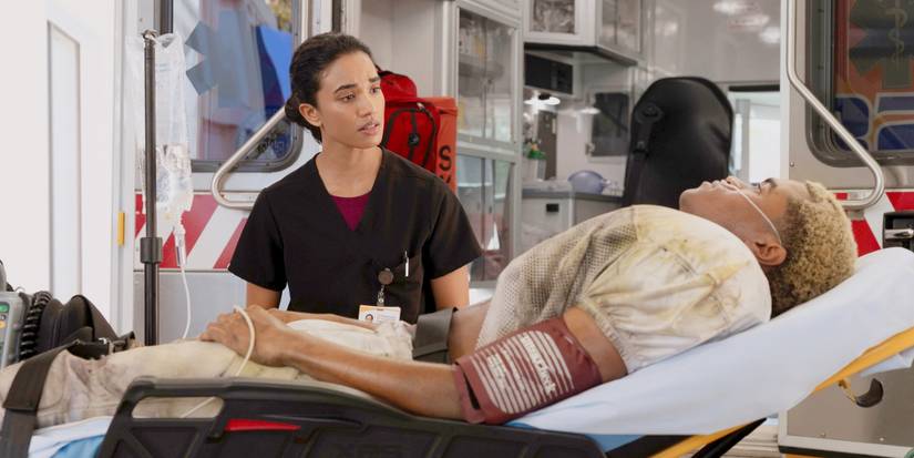 Dr. Mohan sitting by a new patient and looking concerned in The Pitt Season 2 Episode 7