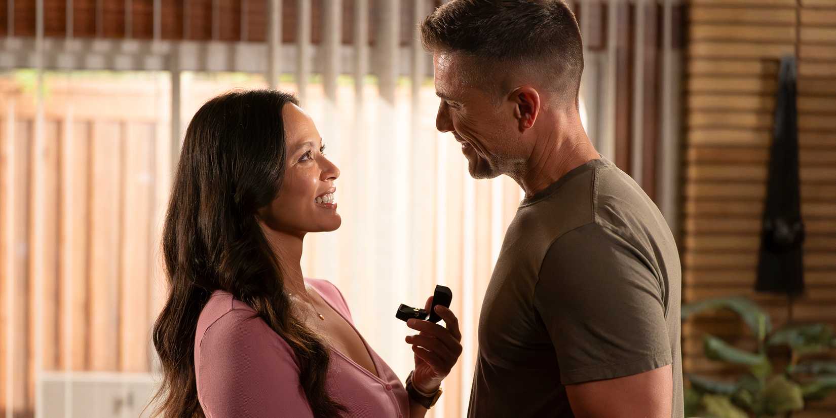 Melisssa O'Neil as Lucy smiling up at Eric Winter as Tim in The Rookie Season 8