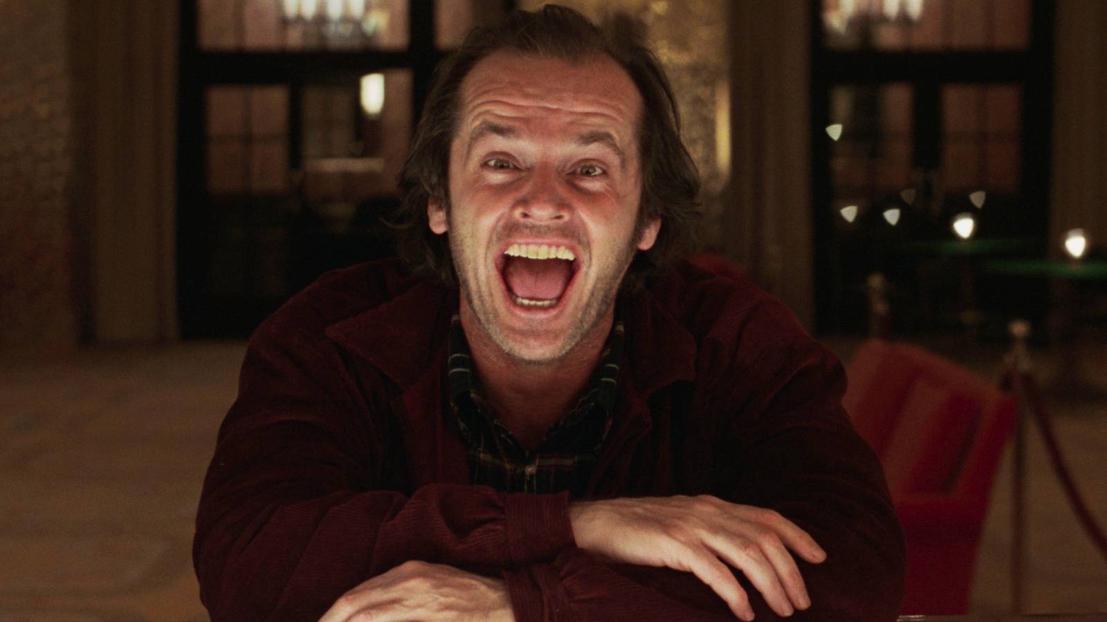 Jack Nicholson as Jack Torrance sitting at a bar and looking mad in The Shining (1980)