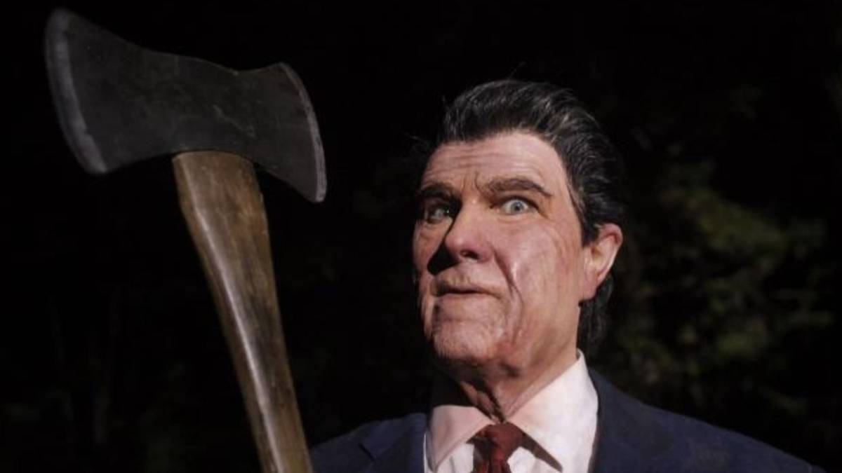 A killer in a Ronald Reagan mask holds an axe in 'The Tripper'