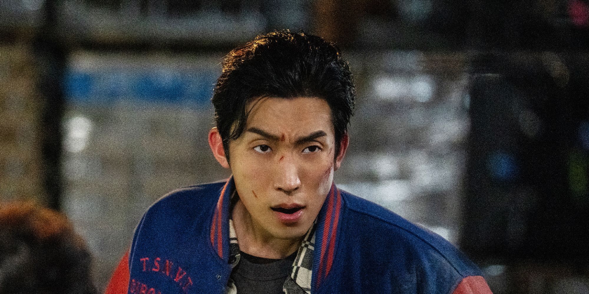 Lee Sang-yi frowning at someone off-screen, with scratches on his face, in Bloodhounds