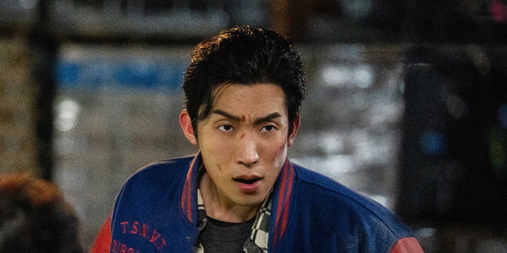 Lee Sang-yi frowning at someone off-screen, with scratches on his face, in Bloodhounds