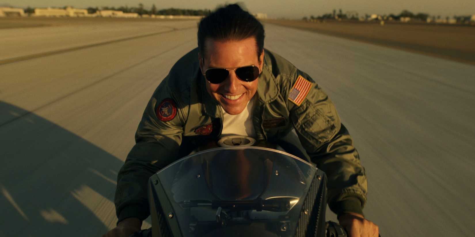 Tom Cruise driving a motorcycle at a high speed in Top Gun: Maverick (2022)