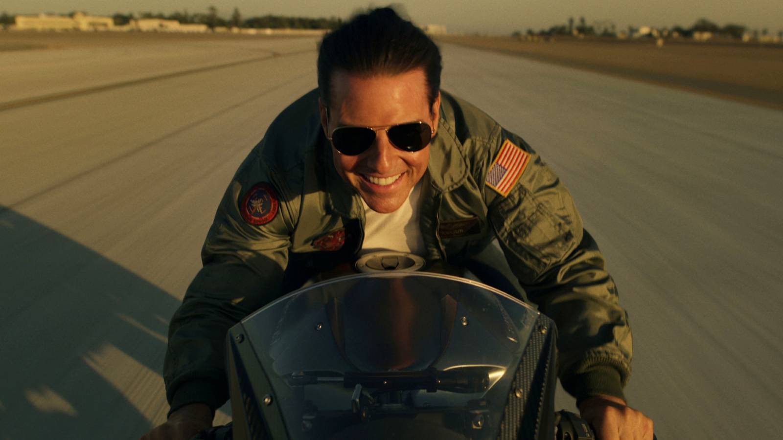 Tom Cruise driving a motorcycle at a high speed in Top Gun: Maverick (2022)