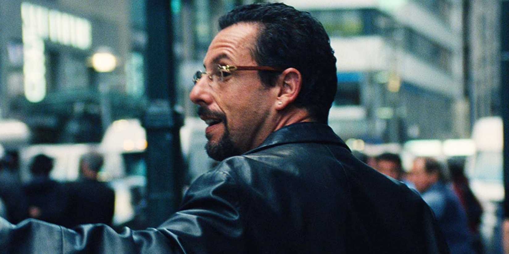 Adam Sandler turning around smiling in Uncut Gems - 2019