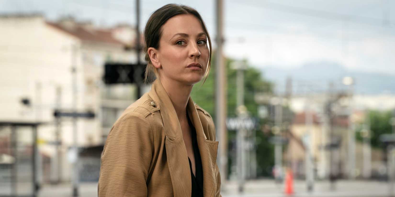 Kaley Cuoco as Alice looking serious in a tan coat in the MGM+ series Vanished