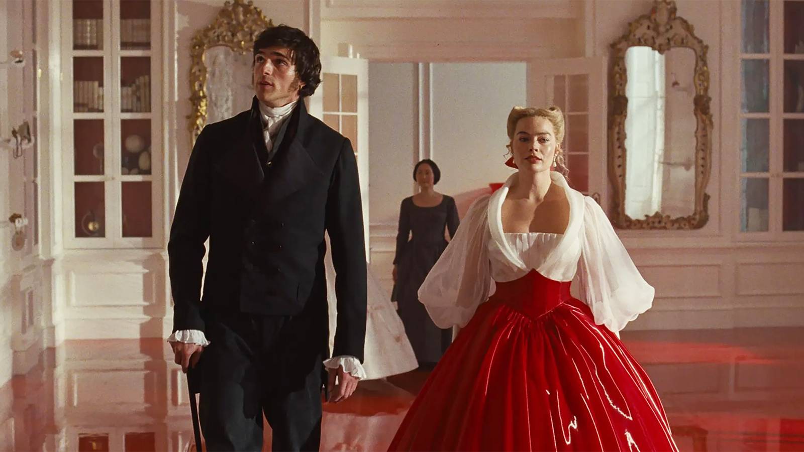 Margot Robbie as Catherine and Jacob Elordi as Heathcliff walking together in Thrushcross Grange in Wuthering Heights