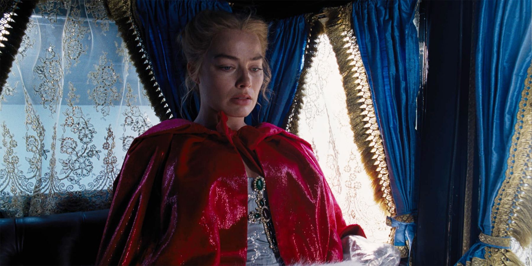 Margot Robbie as Catherine sitting in a carriage in Wuthering Heights