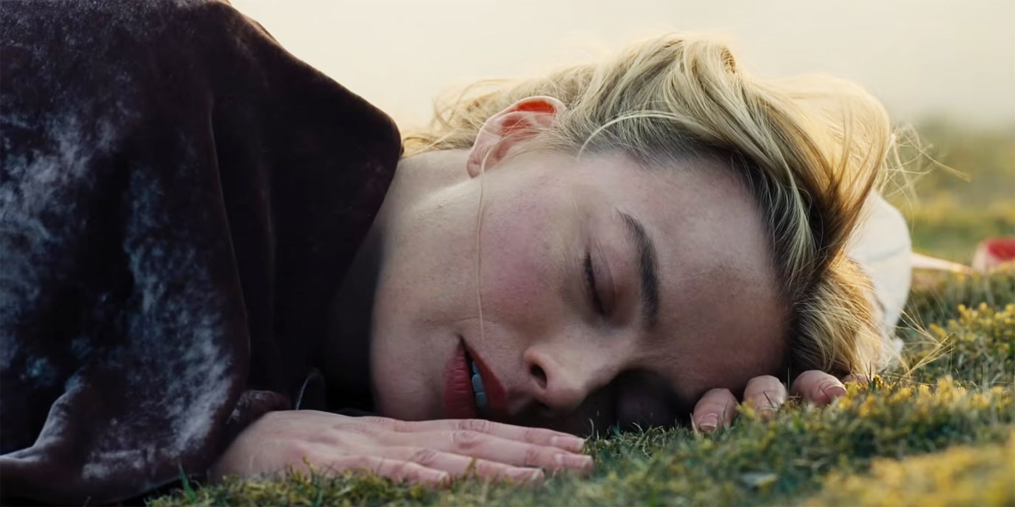 Margot Robbie as Catherine lying on the ground in Wuthering Heights