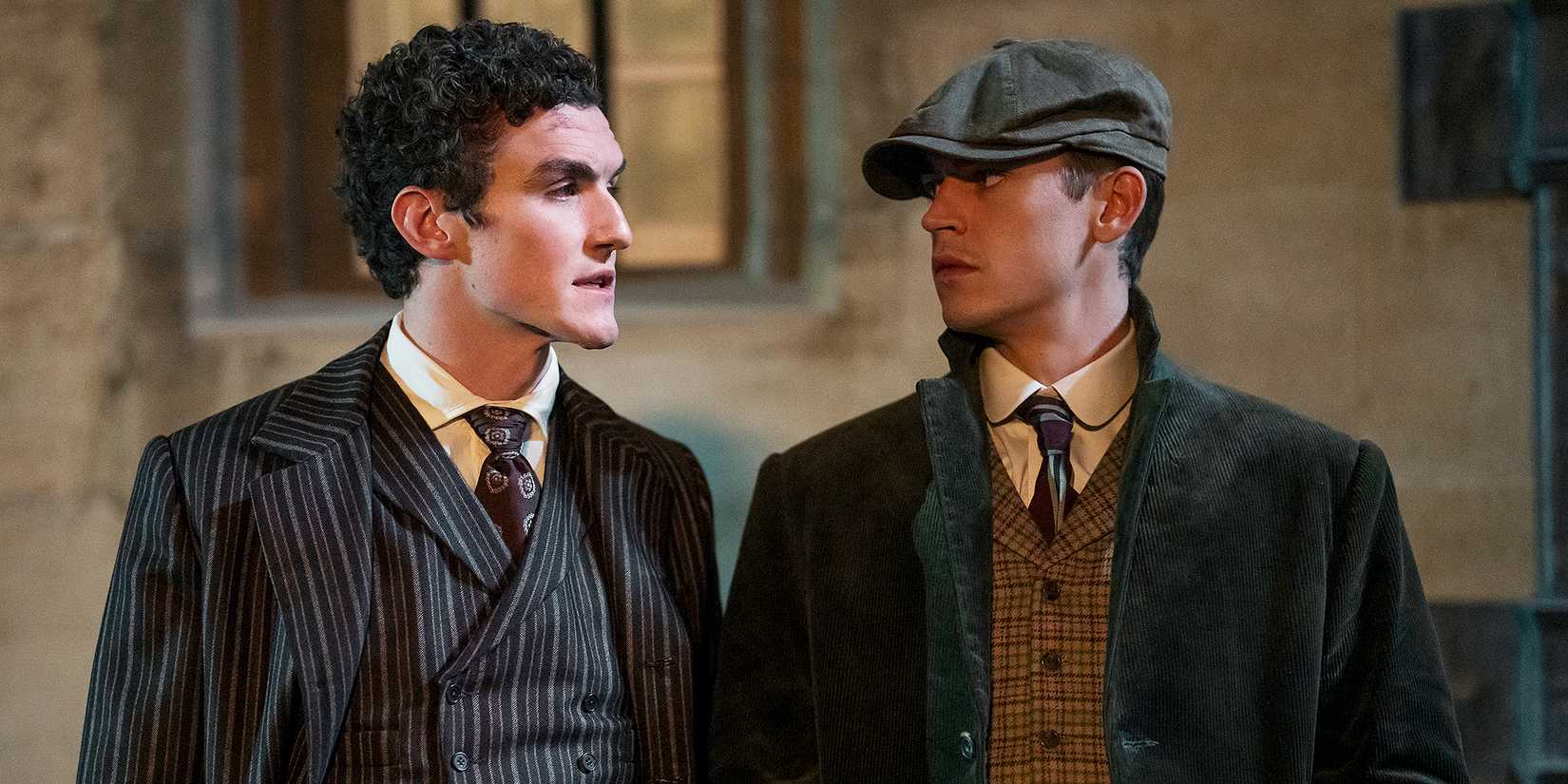 Hero Fiennes Tiffin as Sherlock Holmes and Dónal Finn as James Moriarty looking at each other in Young Sherlock