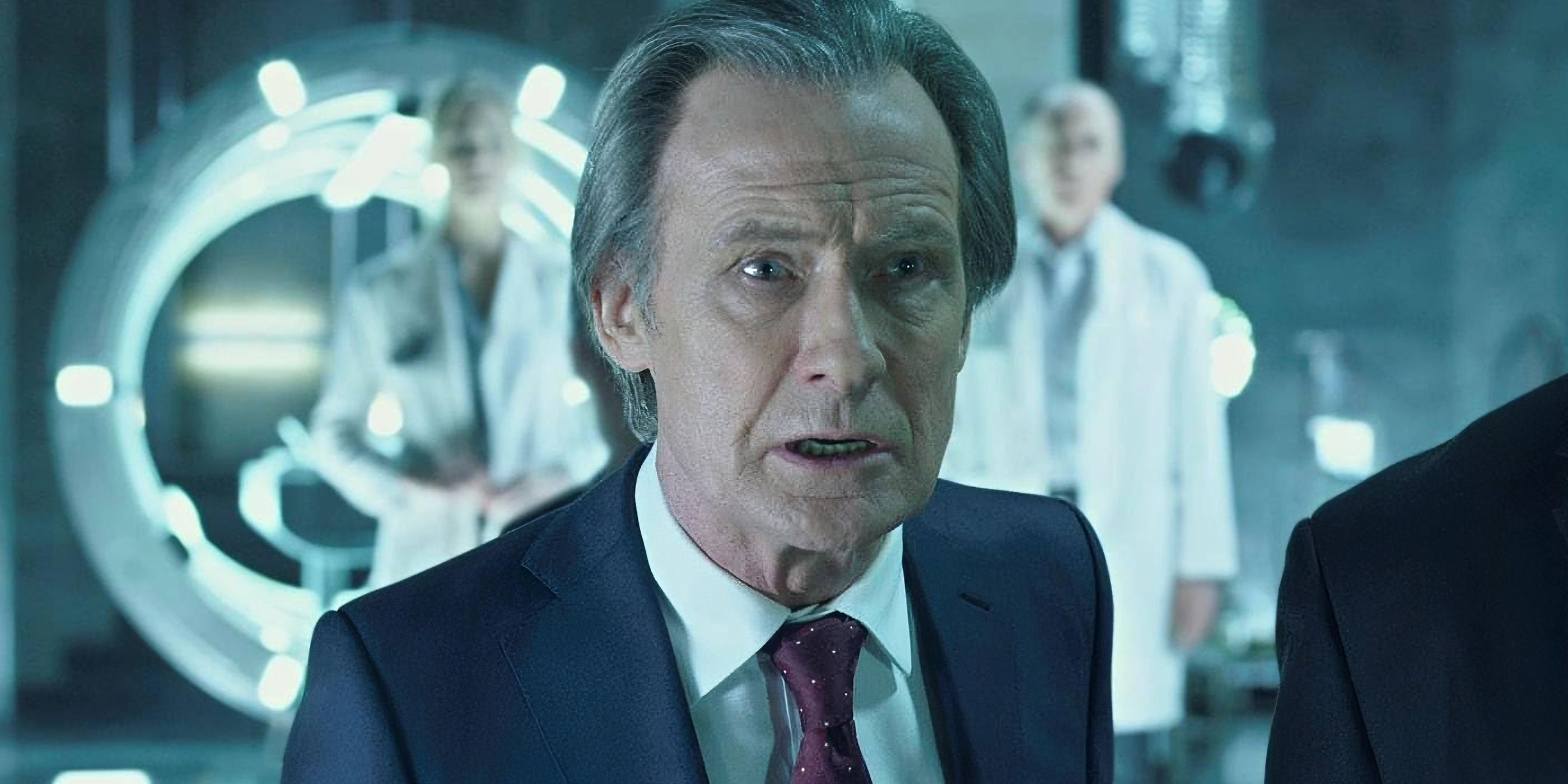 Bill Nighy wearing a suit and stood in a laboratory in 'I, Frankenstein'