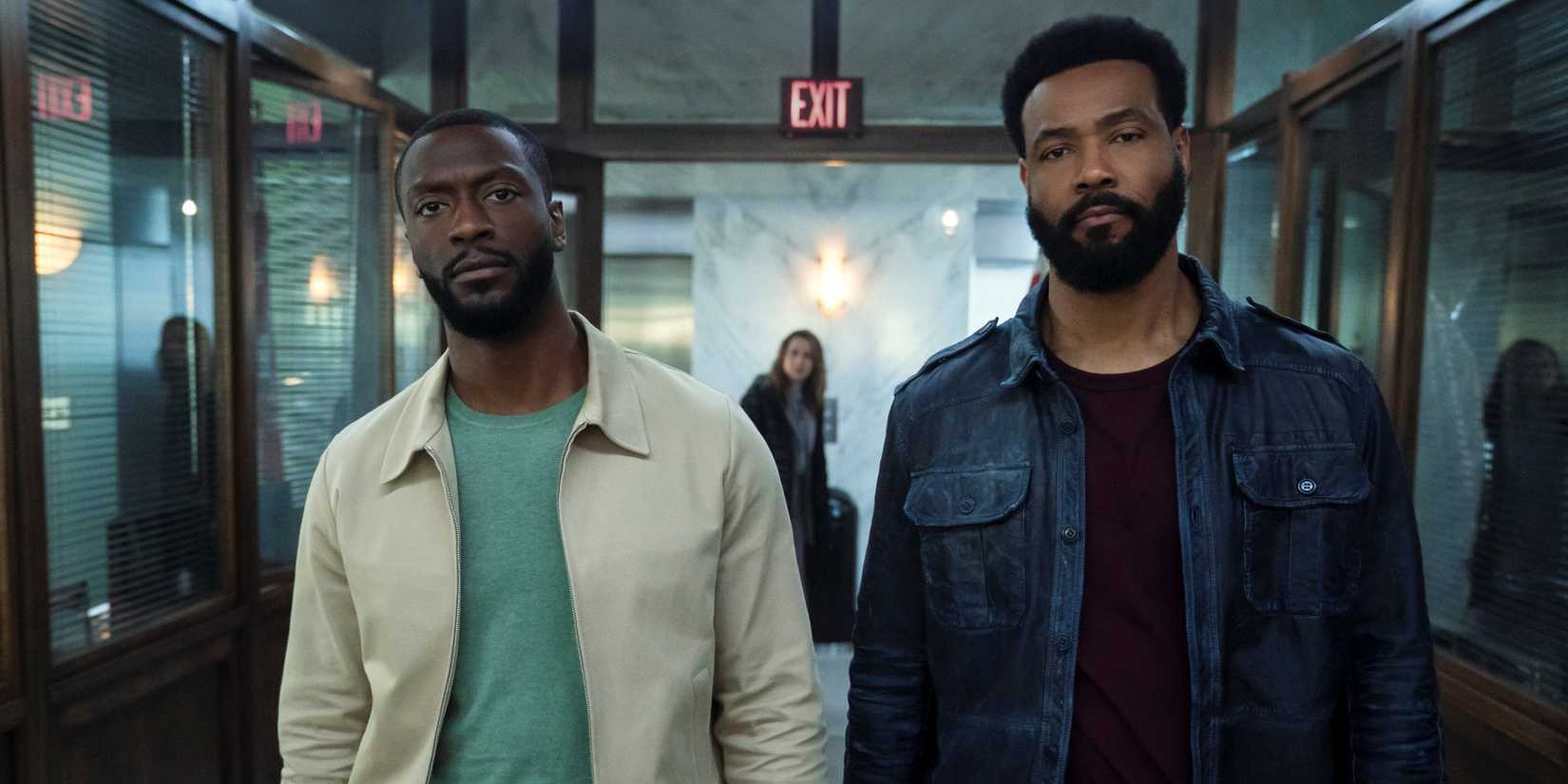 Aldis Hodge as Alex Cross walking down the precinct hallway with Isaiah Mustafa as Sampson in Cross Season 2