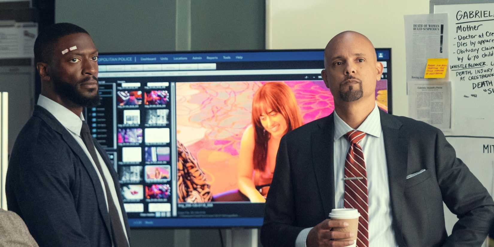 Aldis Hodge as Alex Cross standing next to Ben Watkins as Roy as they work on a case in Cross Season 2