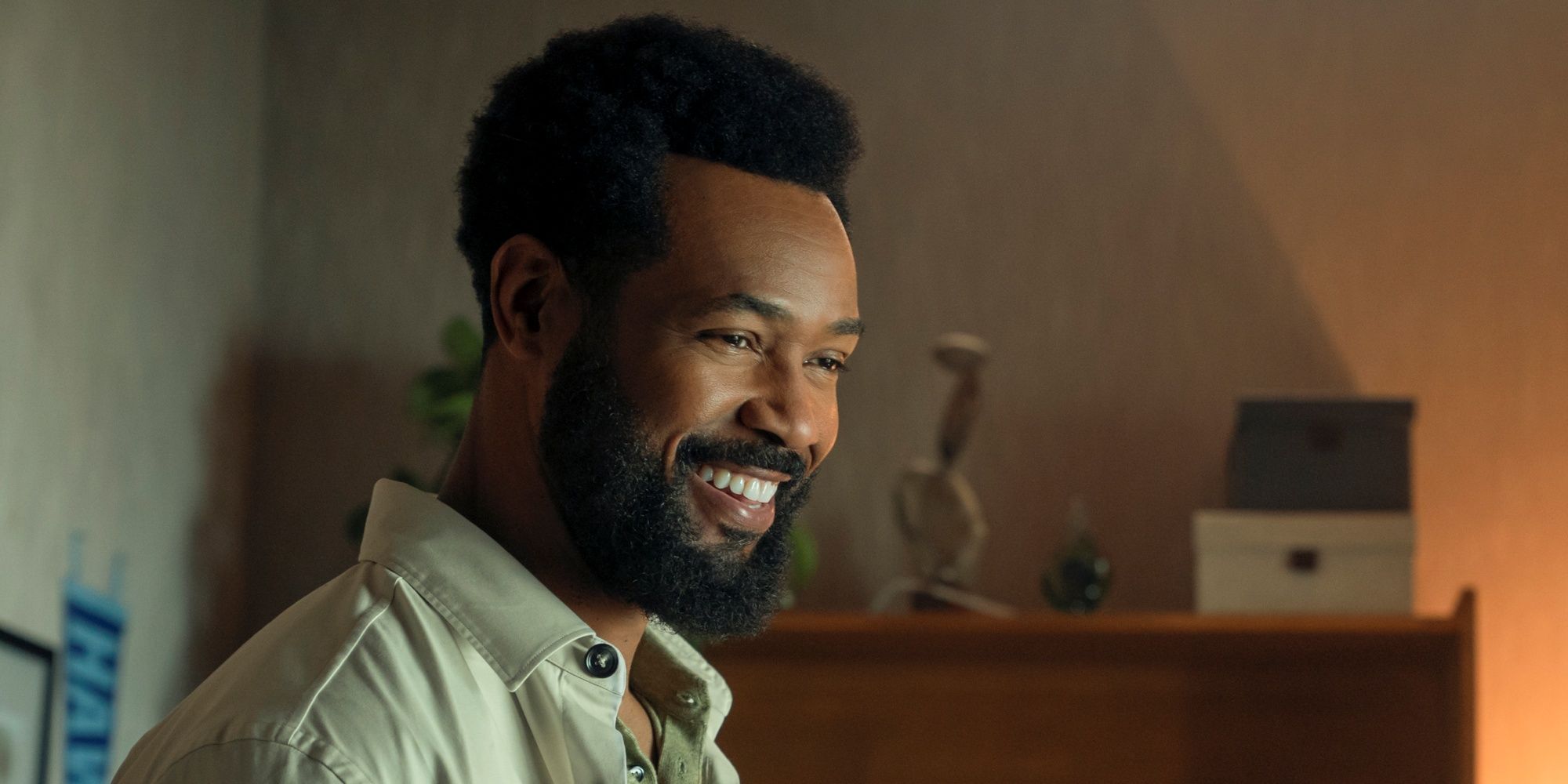 Isaiah Mustafa as John Sampson smiling in a side shot in Cross Season 2
