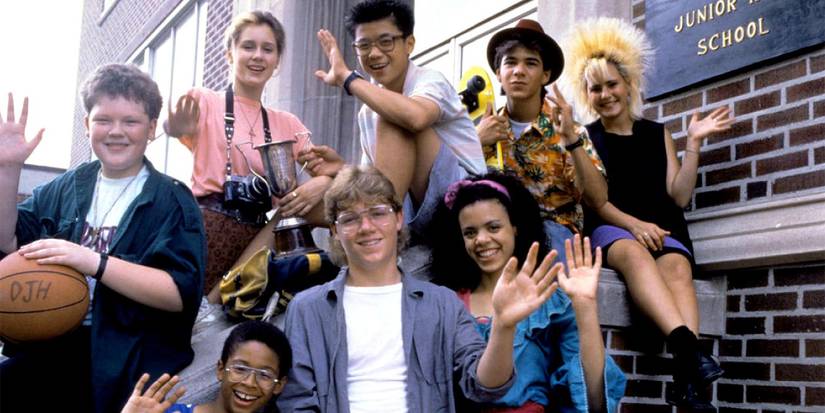The cast of Degrassi Junior High posing outside the school.
